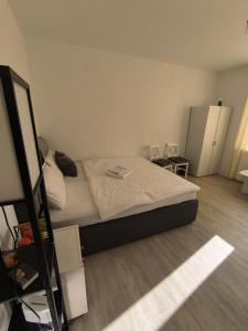 a small bedroom with a bed and a refrigerator at Central Hostel Nurnberg in Nuremberg