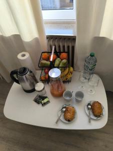 a white table with food on top of it at Central Hostel Nurnberg in Nuremberg