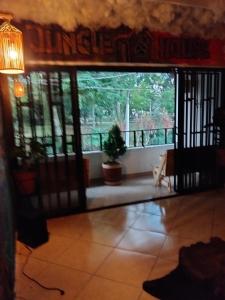 an open door to a living room with a window at Jungle house private room in Medellín