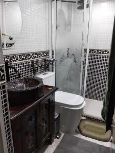 a bathroom with a toilet and a shower and a sink at Jungle house private room in Medellín