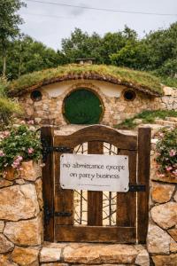a stone building with a gate with a sign on it at Mobbiton Mostar - Magical Underground Retreat in Mostar