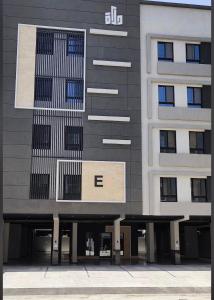 a tall building with two benches in front of it at Riwaq suite in Jeddah