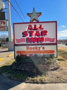 a sign for an all star inn on a street at All Star Inn in Bunkie +1 photo