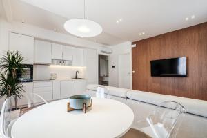a living room with a white couch and a table and chairs at Olive Tree Apartments by In Property in Bečići