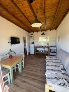 a living room with a couch and a table at Casa Lobos en Chapadmalal in La Estafeta