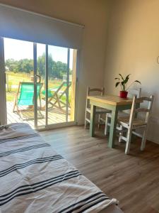 a room with a table and chairs and a patio at Casa Lobos en Chapadmalal in La Estafeta
