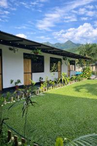 a house with a lawn in front of it at La Posada de Chango in La Merced
