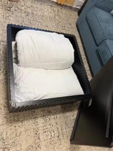 two white pillows in a black box on the floor at King Suite and Sofa Bed Fast WI-FI Easy DC Access in District Heights