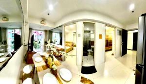 a large room with a living room with sinks and mirrors at 2BR Burnham Hill Condominium in Baguio