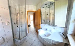 a bathroom with a sink and a shower at Ferienwohnung Sonnenwinkl in Reit im Winkl