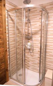 a shower with a glass enclosure in a bathroom at Le Cervin Lodge in Breuil-Cervinia +16 photos