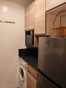 a small kitchen with a dishwasher and a washer at Le Cervin Lodge in Breuil-Cervinia