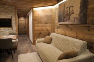 a living room with a couch and a table at Le Cervin Lodge in Breuil-Cervinia