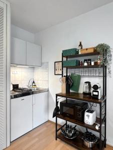 a small kitchen with a counter and a microwave at Modern, Gemütlich mit WLAN, TV in Essen