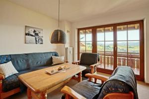 a living room with a couch and a table at StaigAllgäublick in Sonthofen
