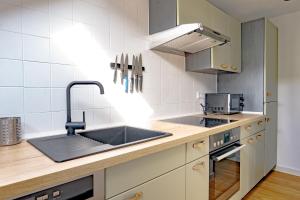 a kitchen with a sink and a stove at Spitzkehren in Blaichach