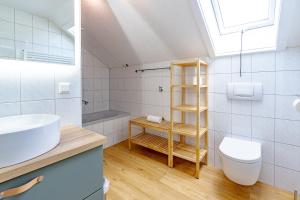 a bathroom with a sink and a toilet at Spitzkehren in Blaichach +1 photo