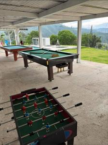 two ping pong tables sitting on top of a patio at Apartamentos campestres la Divisa in Santa Rosa de Cabal