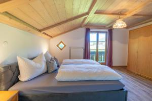 a bedroom with a bed and a couch at Landhaus Waibel in Blaichach