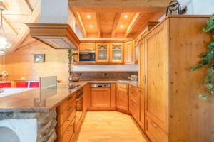 a kitchen with wooden cabinets and a counter top at Landhaus Waibel in Blaichach +6 photos