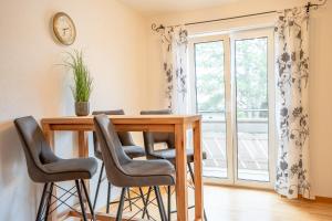 a dining room table with chairs and a window at Bergfink in Waltenhofen