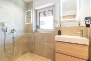 a bathroom with a shower and a sink at Fewo Blick in die Berge in Ofterschwang