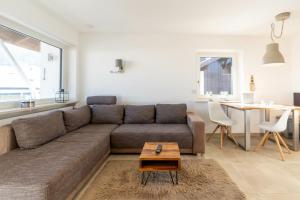 a living room with a couch and a table at Fewo Blick in die Berge in Ofterschwang