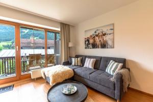 a living room with a couch and a table at Gipfelliebe in Bad Hindelang