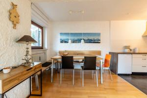 a kitchen and dining room with a table and chairs at Entschenkopf in Bolsterlang