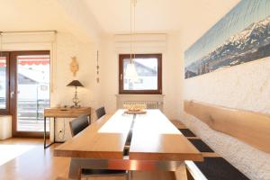 a dining room with a wooden table in a room at Entschenkopf in Bolsterlang +7 photos
