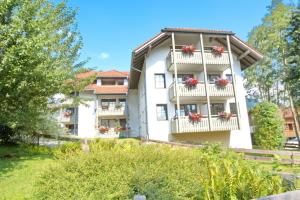 a white apartment building with flowers on balconies at Bergfriede in Bad Hindelang