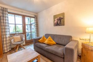 a living room with a couch and a chair at Bergfriede in Bad Hindelang