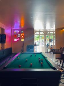 a billiard room with a pool table in it at Auberge Les Mufliers - Hôtel Les Forges in Pontenx-les-Forges