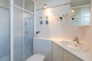 a bathroom with a toilet and a sink and a shower at Ifen in Fischen