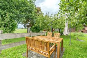 a wooden table with two chairs and an umbrella at Stolz 1 in Blaichach