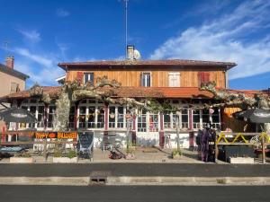 a large building with a building with at Auberge Les Mufliers - Hôtel Les Forges in Pontenx-les-Forges