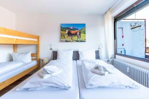 two twin beds in a room with a window at Bergerwachen in Bolsterlang