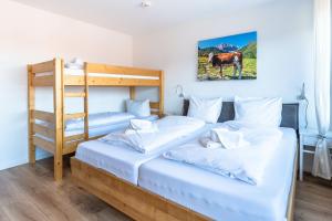 a bedroom with two bunk beds and a ladder at Bergerwachen in Bolsterlang +1 photo