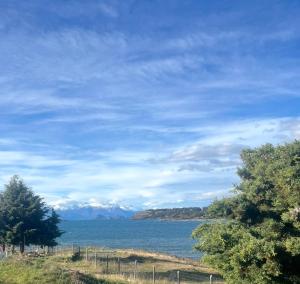 a view of a body of water with mountains at Cabañita Coyhaique in El Cerrillo