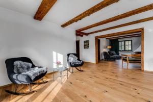 a living room with two chairs and a table at Landhaus Hoch 10 in Burgberg