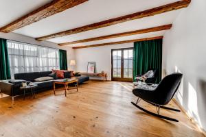 a living room with a couch and a table at Landhaus Hoch 10 in Burgberg