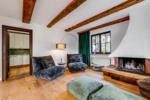 a living room with two chairs and a fireplace at Landhaus Hoch 10 in Burgberg