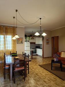 a kitchen and living room with a table and chairs at Fimar in Torre Lapillo