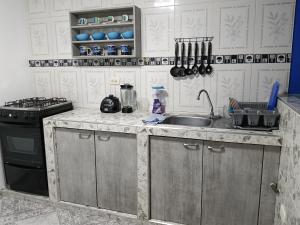 a kitchen with a sink and a stove at Van Gogh Duitama in Duitama