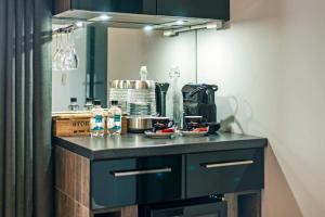 a kitchen with a black counter with a coffee maker at Tinwood Estate Vineyard Lodges in Chichester