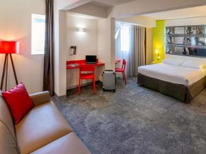 a hotel room with a bed and a desk at ibis Styles Cannes Le Cannet in Cannes +108 photos