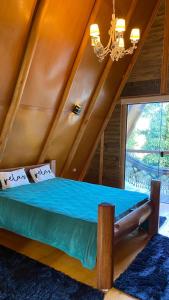 a bedroom with a bed in a room with a ceiling at Chalé Dengo Dengo - Refúgio Romântico na Serra da Mantiqueira in Pindamonhangaba