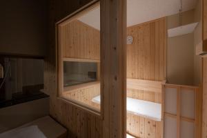 a sauna with wooden walls and a window at HOTEL MYTH-U -Adult only in Wakayama