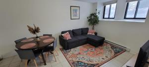 a living room with a couch and a table at Comfortable condo in Montreal in Montreal