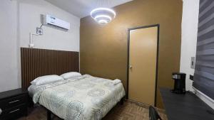 a bedroom with a bed and a door in it at Estudios Hotel Colonial in Escárcega +13 photos
